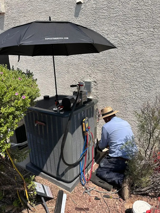 HVAC technician performing outdoor AC maintenance in Kingsbury