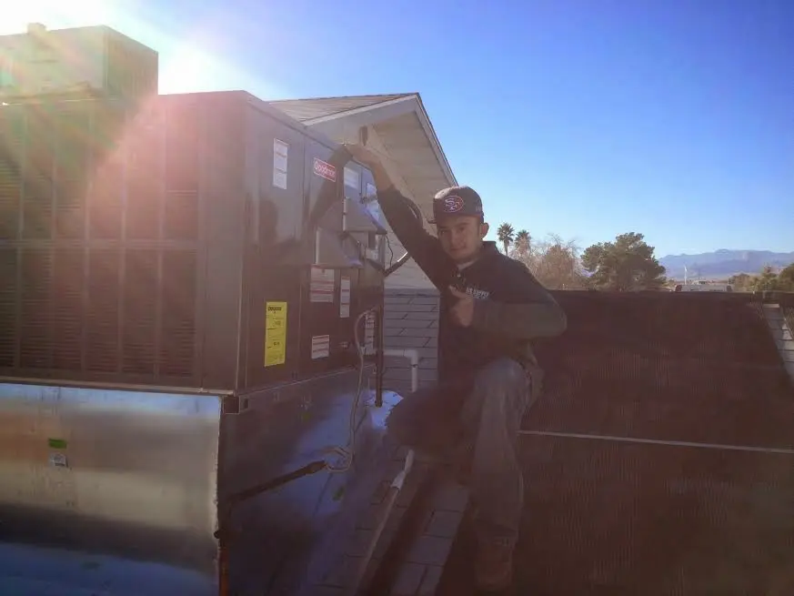 HVAC technician performing HVAC Inspection on a rooftop unit in Kingsbury